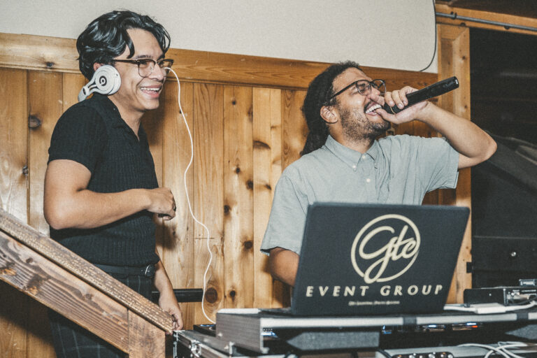 Two DJs performing at an event together